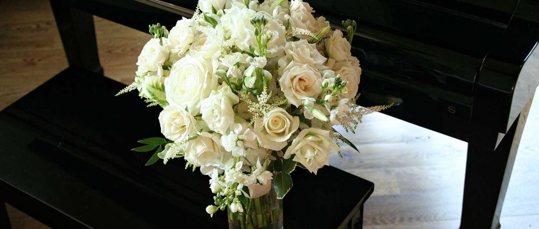 White Bridal Bouquet On Piano Bench