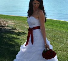 Gorgeous Bride With Red Rose Bouquet Beside Lake