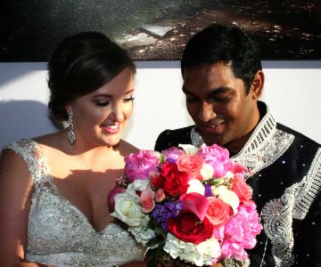 Handsome bride and groom with colorful bouquet
