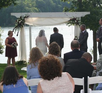 Hanging crystals adorn wedding pergola