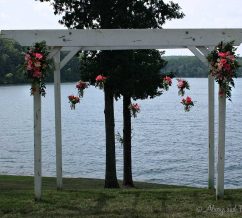 Simple pergola sprays with hanging jar arrangements