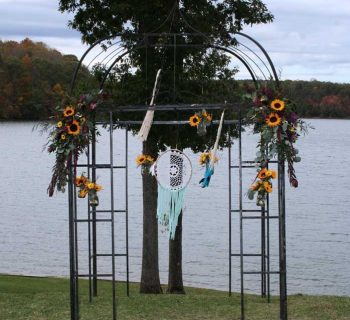 Black iron wedding archway with sunflowers