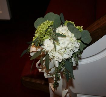 Hydrangea wedding aisle pew arrangement