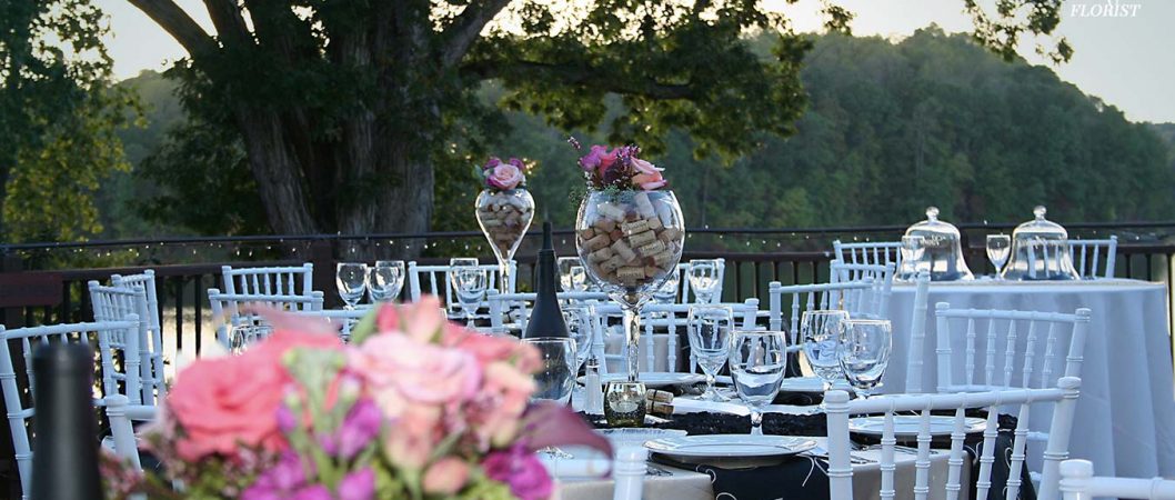 Large cork filled wine flasks topped with flowers