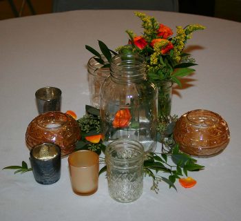 Ruscus and spray roses in mason jars