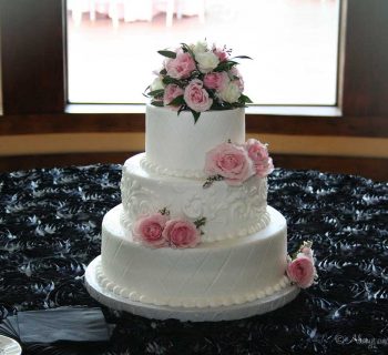 Three tiered cake with rose adornments